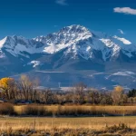 a majestic snow-capped mountain rising above a picturesque valley in bozeman, montana.